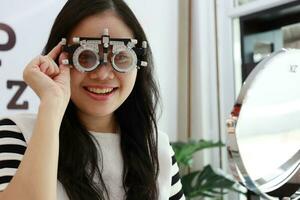 Thai lady wearing eyeglasses inside the clinic, woman in optical photo