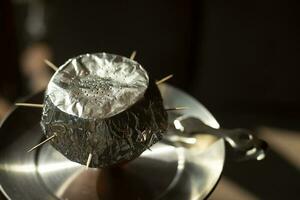 Foil on hookah. Ignition of coals in hookah. Smoking is harmful to health. photo