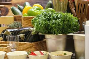 Products in bowl  and basket prepared for cooking classes in kitchen of restaurant. Cooking master class. Training by professional chef. Preparing a various colorful vegetables photo