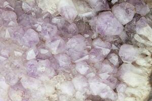 Close-up of natural violet amethyst druse geode mineral crystal unpolished semi-precious gemstone. Magic rock for ritual, witchcraft, spiritual practice, meditation. Esoteric life balance concept photo