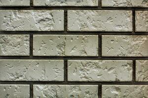 Decorative granite cobble stone tile brick wall texture background. Seamless pattern backdrop. Crafted modern brickwork outer wall. House exterior with sandstone blocks tiled photo