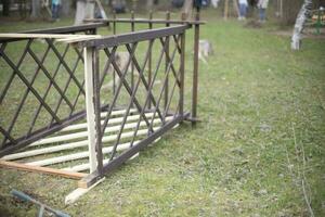 Wooden construction. Structure lies on grass. Wooden beams. photo