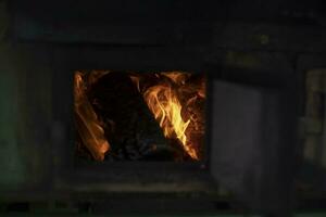 Fire from firewood. Burning firewood in oven. Kindling Field Kitchen. Military cuisine. photo