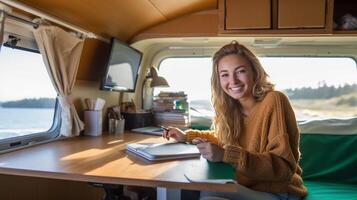 Happy Young Adult Female Enjoying Working Remotely Inside Her RV Camper Trailer - . photo