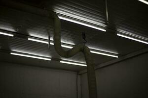 Fluorescent lamps in workshop. Indoor lamps. Light in industrial area. photo