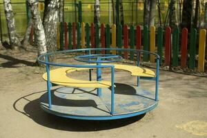 Carousel on playground. Empty playground. Attraction for toddlers. photo