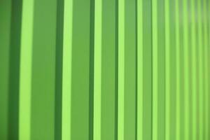 Green fence. Fence in detail. Ribbed steel. photo