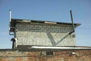 Construction of blocks. Sauna on roof of garage. Grey wall. photo