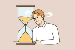 Unhappy bored man look at hourglass tired of long waiting. Upset sad male observe sandglass checking time counting minutes. Boredom and anticipation. Flat vector illustration.