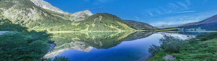 Panoramic view over Vilsalpsee lake in Tannheimer Tal valley, Austria photo