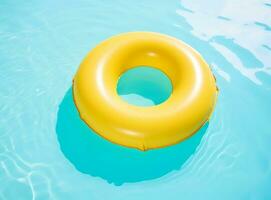 A blue bottom swimming pool with blue water below a large yellow rafting in the mid photo