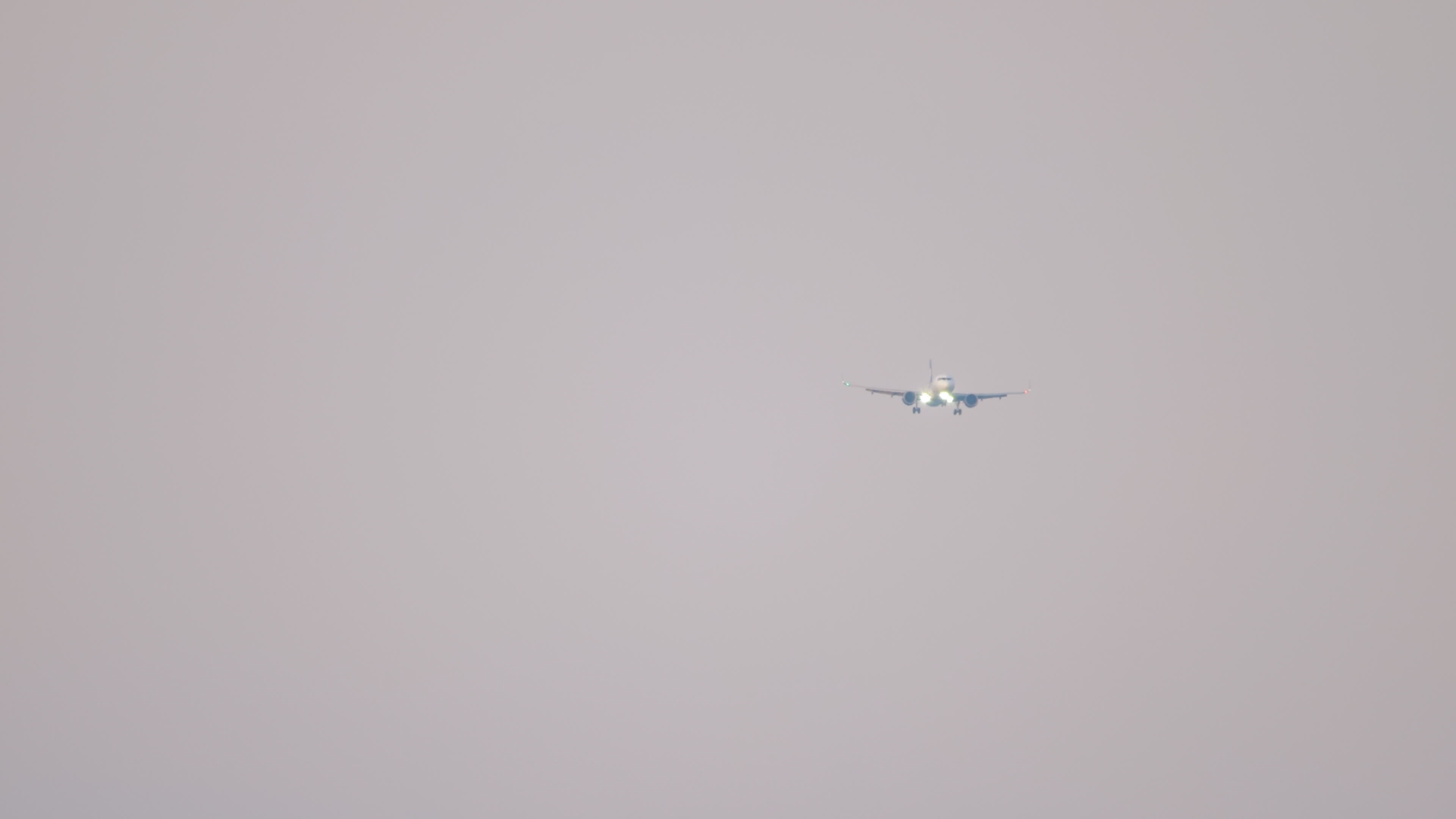 Panoramic view long shot, unrecognizable aircraft approaching landing