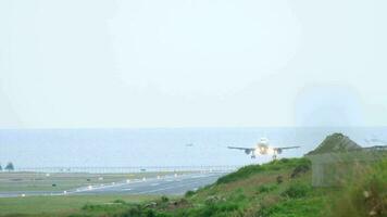 Front view of passenger plane descending before landing. Runway on the background of the sea video