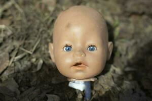 Doll head. Toy baby. Baby head made of plastic. photo