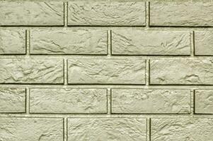 Decorative granite cobble stone tile brick wall texture background. Seamless pattern backdrop. Crafted modern brickwork outer wall. House exterior with sandstone blocks tiled photo