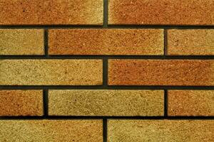 Decorative granite cobble stone tile brick wall texture background. Seamless pattern backdrop. Crafted modern brickwork outer wall. House exterior with sandstone blocks tiled photo