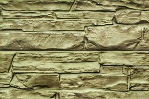 Decorative granite cobble stone tile brick wall texture background. Seamless pattern backdrop. Crafted modern brickwork outer wall. House exterior with sandstone blocks tiled photo