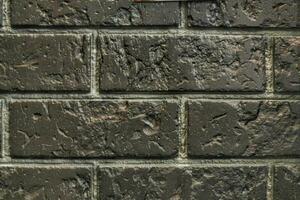 Decorative granite cobble stone tile brick wall texture background. Seamless pattern backdrop. Crafted modern brickwork outer wall. House exterior with sandstone blocks tiled photo