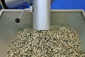 Close-up of plastic waste polymer granules. Biodegradable plastic pellets on factory. Grey crushed chemical granules for industrial recycled production. PVC granulate on plant. Pollution reduction photo