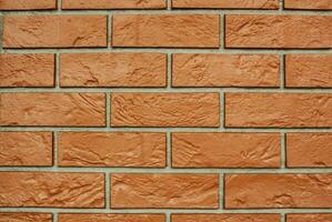 Decorative granite cobble stone tile brick wall texture background. Seamless pattern backdrop. Crafted modern brickwork outer wall. House exterior with sandstone blocks tiled photo