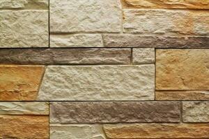 Decorative granite cobble stone tile brick wall texture background. Seamless pattern backdrop. Crafted modern brickwork outer wall. House exterior with sandstone blocks tiled photo
