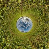 blue hole sphere little planet inside green grass round frame background. photo