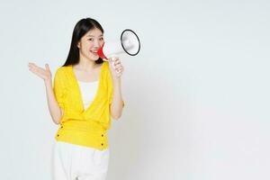 Young woman holding megaphone isolated on white background. Lifestyle summer and announce concept. photo