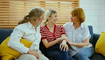 Happy family sitting on sofa and watching tv at home. photo