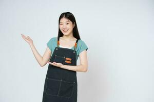 Happy smiling woman chef holding something on palm of hand over white background. photo