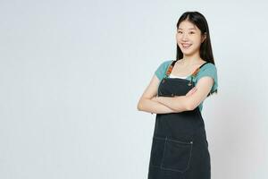 Happy woman chef or cook in apron standing isolated over white background. photo