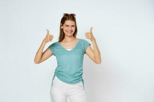 Young woman showing thumbs up isolated on white background. photo