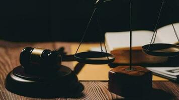 Justice and law concept.Male judge in a courtroom with the gavel, working with, computer and docking keyboard, eyeglasses, on table in morning light video
