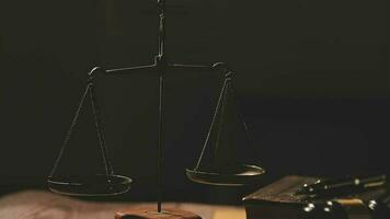 Justice and law concept.Male judge in a courtroom with the gavel, working with, computer and docking keyboard, eyeglasses, on table in morning light video