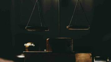 Justice and law concept.Male judge in a courtroom with the gavel, working with, computer and docking keyboard, eyeglasses, on table in morning light video