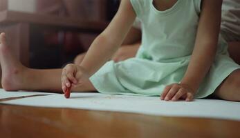 Girl kid drawing with crayons. photo