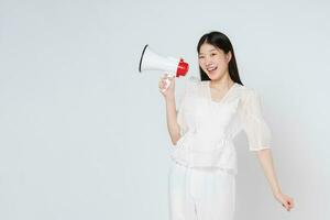 Young woman holding megaphone isolated on white background. photo