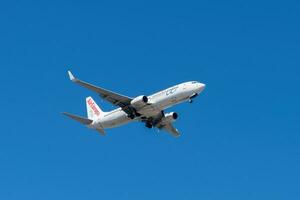 Spanish company Air Europa with Boeing 737-800 approaching to land at Lisbon International Airport against blue sky photo