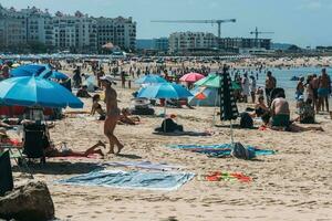 Crowded beach at Sao Martinho do Porto, Portugal on a summer day photo