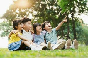 group of cute asian kids having fun in the park photo