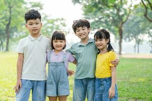 group of cute asian kids having fun in the park photo