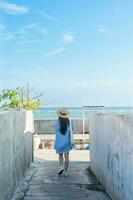 image of a girl and a clear blue beach photo