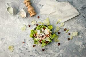 Concept for a tasty and healthy vegetarian meal. Top view Greek salad on stone background. vegetable organic Salad. photo