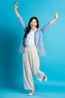 Asian young businesswoman portrait on blue background photo