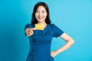 Portrait of beautiful woman in blue dress, isolated on blue background photo