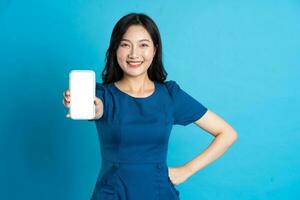 Portrait of beautiful woman in blue dress, isolated on blue background photo