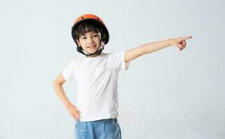 portrait of asian boy wearing orange helmet on white background photo