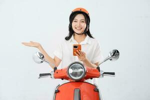 a woman wearing a helmet and driving a motorcycle photo