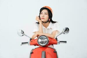 a woman wearing a helmet and driving a motorcycle photo