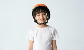 portrait of asian boy wearing orange helmet on white background photo