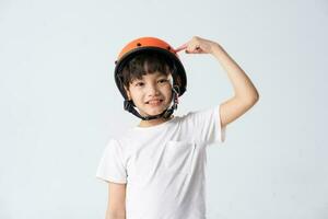 portrait of asian boy wearing orange helmet on white background photo
